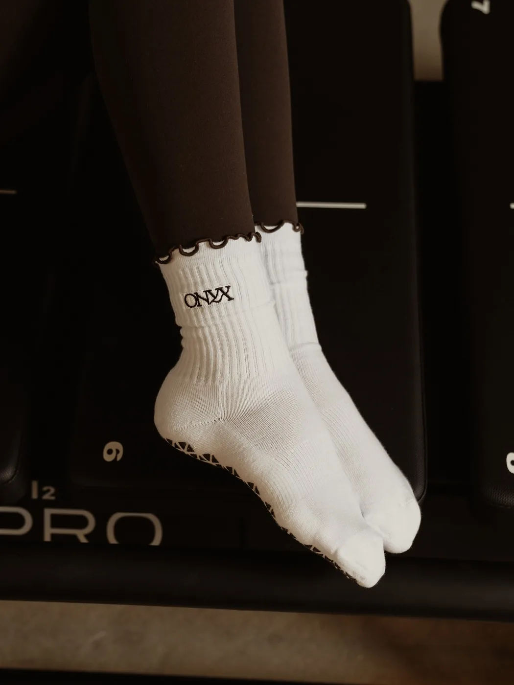 Onyx grip socks resting on a Mega Pro carriage in the Menifee studio